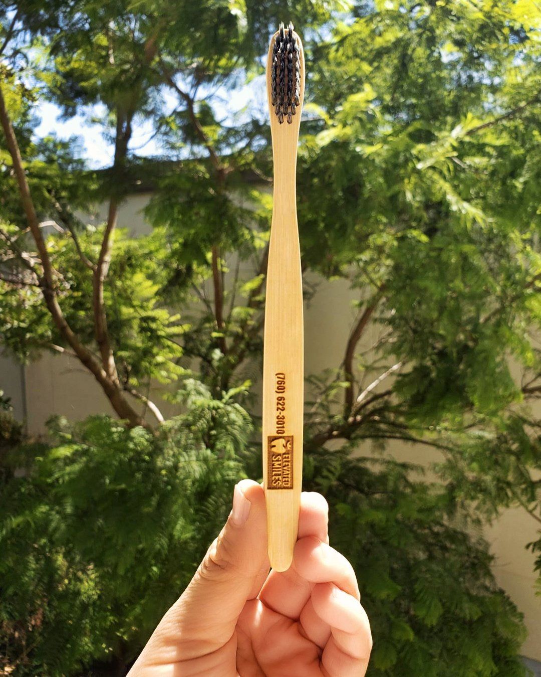 A bamboo toothbrush by Elevated Smiles in Carlsbad